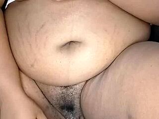 The ebony stepmother indulges in solo masturbation, her big pussy lips wet and ready for orgasm.