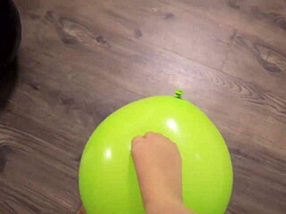 Girl in pantyhose plays with balloons carefully