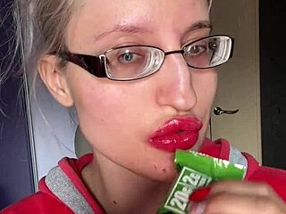 giantess with big lips and eyeglasses contrasts huge tall fetish while eating snickers protein bar
