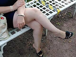 Intriguing blonde milf with sexy legs and shaved pussy teases in high heels at outdoor park