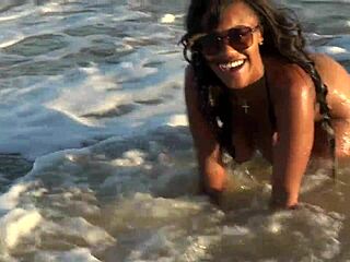 Ebony beauty boldly strips naked shaking big ass at public beach
