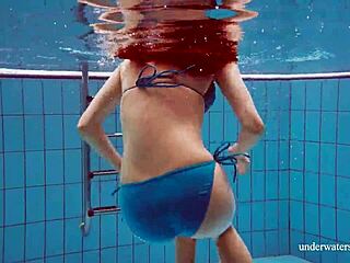 Martina shows off her tight pussy in a blue bikini during an underwater swim at the pool.