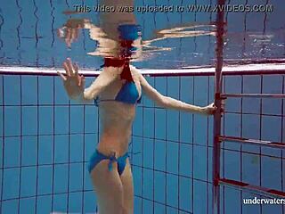 Martina shows off her tight pussy in a blue bikini during an underwater swim at the pool.