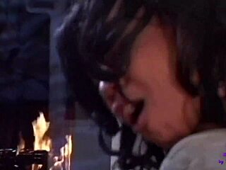 Big black cock hints at deep anal pleasure near the warm fireplace glow with cum on her face