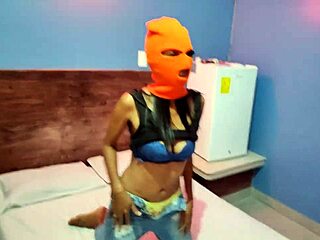 brunette masked beauty shakes hips sexy before getting naked