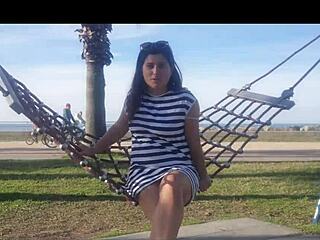 naked brunette bends over public beach