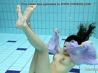 aneta dives nude into pool underwater