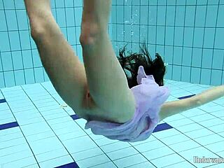aneta dives nude into pool underwater