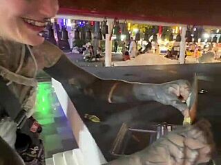 A quirky thai lady feeds stray cats in crazy thailand scene