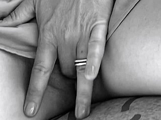 She teases her pussy with subtle fingers under the desk table