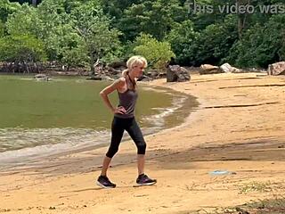 Public beach handjob erupts into homemade sex