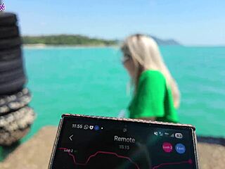 pretty milf teases with remote vibrator on public beach walk