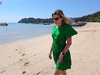 pretty milf teases with remote vibrator on public beach walk