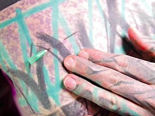 Tattooed beauty fists ass in wild solo play