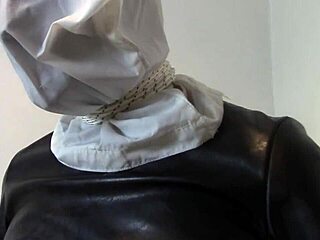 Hooded wife endures humiliating leather bondage and pee desperation