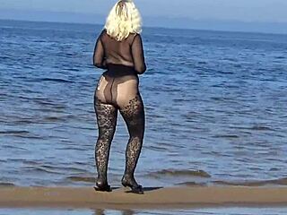 Milf flashes big tits pussy on public beach