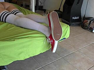 sneaker-clad feet dangle teasingly into socks and thong