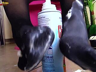 brunette in pantyhose gives footjob to cream tube